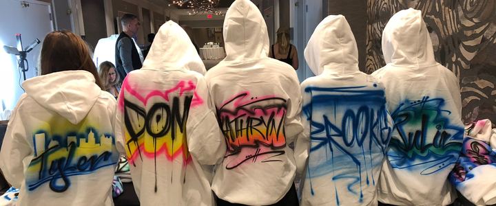 Five guests showing airbrushed hoodies