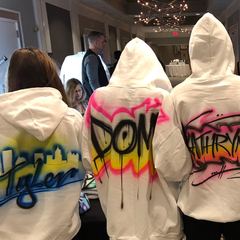 Guests wearing airbrushed hoodies